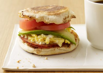 Egg and Canadian bacon sandwiches with avocado and tomato
