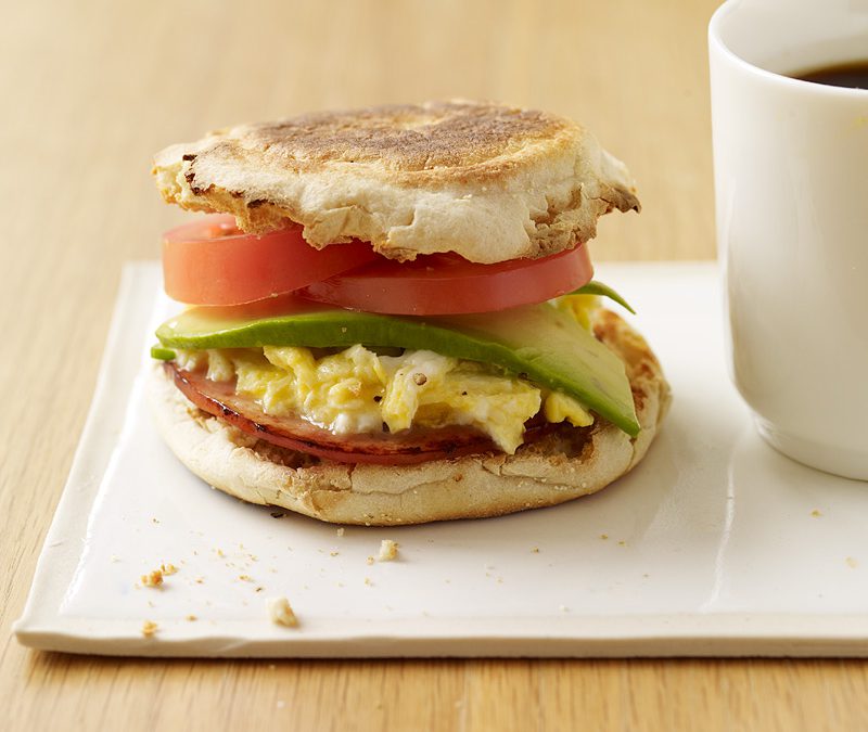 Egg and Canadian bacon sandwiches with avocado and tomato